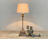 Table lamp made of iron candle holder with antique finish.